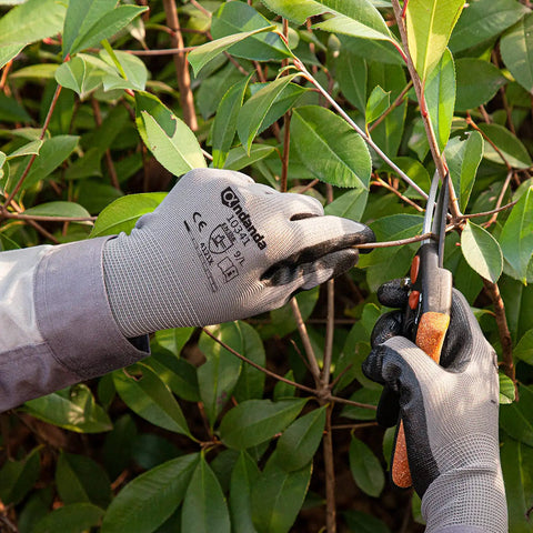 Person using Smart Touch Work Gloves With Nitrile Grip Palm, 60 Pairs, 3D Comfort Stretch Fit, Ambidextrous Seamless Knit Nylon, Tough Black Gloves For Warehouse Hustle, Logistics, And Handling, Size Large, trimming plants.