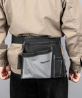 Back view of Heavy Duty Carpenter Apron With Five Pockets Adjustable 32 To 56 Inch Waist Durable Canvas Tool Belt on person