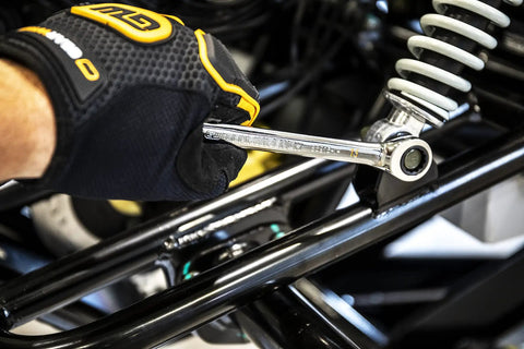 Person using 10mm 4 Degree Swing Arch 12 Point Ratcheting Combination Wrench With Off Corner Loading on machinery