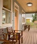One Light Integrated LED Flush Mount Ceiling Light For Indoor And Outdoor Use on a porch in matte black finish, frosted diffuser