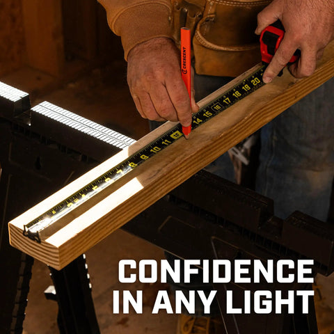 Person using ControlTouch Nite Eye Tape Measure With Anti Pinch Lock on wooden board with 360 degree end hook and 11 foot standout