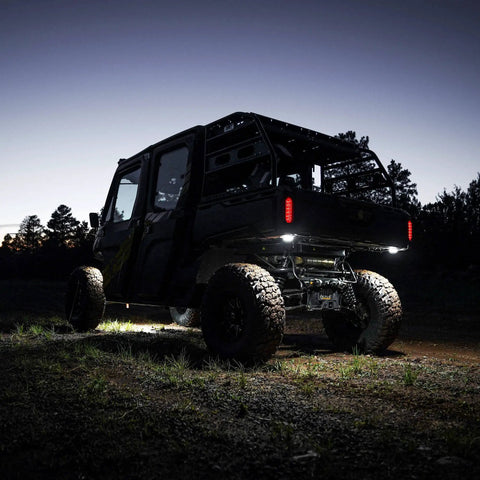 Off-road vehicle using Cyclone V2 LED 5W Flood Beam Light With Clear Lens, Universal Mount, lighting ground in darkness.