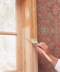 Applying Clear SealCoat Universal Sanding Sealer For Interior Wood And Floors, Fast Drying on a window frame with a brush.