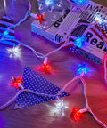 Lit Fourth Of July Decor Red White Blue Stars String Lights 17Ft on wooden table with Independence Day accents