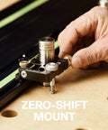 Close-up of a hand using a Zero-Shift Mount on a guide rail clamp, showcasing its sturdy metal construction for workshop tasks.
