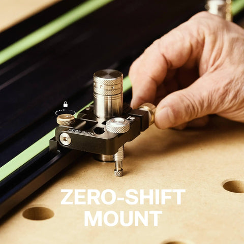 Close-up of a hand using a Zero-Shift Mount on a guide rail clamp, showcasing its sturdy metal construction for workshop tasks.