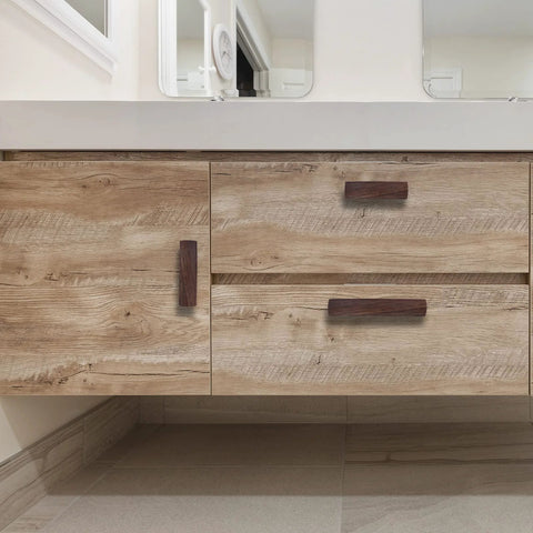 Six Piece Walnut Wood Drawer Handles Set With 2.5 Inch Hole Centers installed on wooden cabinet drawers in a modern bathroom
