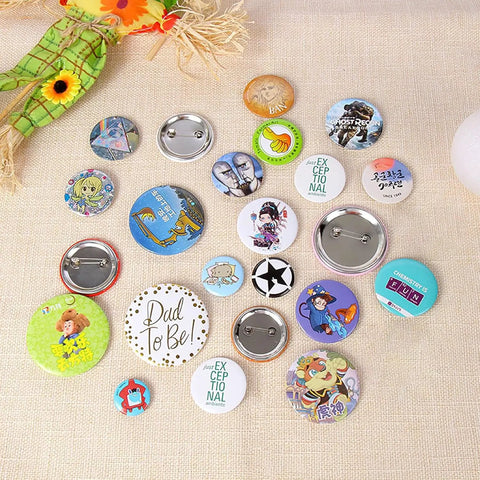 Custom DIY badges made with Dope 58mm Button Maker Kit For DIY Badges With 100 Sets And 10 Bonus Keychains on beige fabric.