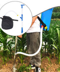 Spreader Backpack Sprayer For Granular Manure And Fertilizer in use, featuring easy grip PVC handle and hose, in cornfield setting.