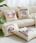 Decorative pillows with quilting designs on a cream sofa, featuring humorous sewing quotes and colorful illustrations.