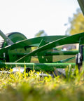 Close-up of No Sweat 14 Inch 5 Blade Push Reel Lawn Mower With Ball Bearing Reel And Cushioned T Style Handle on a lawn