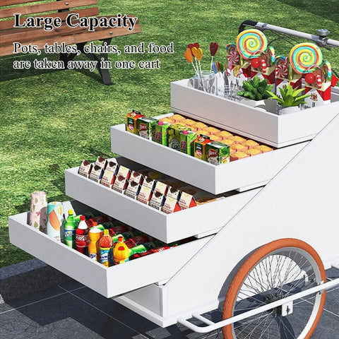 Slick Large Reverse Tricycle Vending Cart With Smooth Pedal Assist Front Loading Frame Four Tier Rollout Rack Sweet Mobile Food Beverage Hustle Rig For Flea Market Gray showing large capacity with four tiers of products.