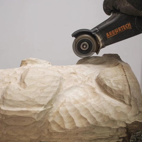 No Nonsense Heavy Hitter 8 Amp Mini Wood Carving Router carving a detailed design on a wooden sculpture.