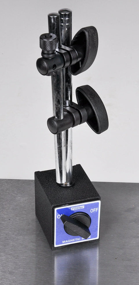 Front view of Fowler magnetic base with chrome vertical posts, black adjustable clamps, on a black base with blue label.