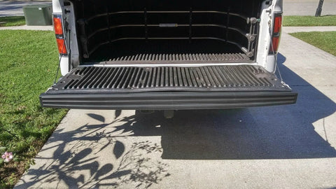ECOTRIC tailgate molding cap installed on Ford F-150 tailgate; black ribbed plastic trim along the open bed edge