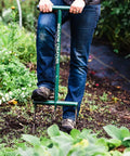 Person using Raised Bed Garden Fork With 9 Inch Tines For Small Plots, Lightweight Metal Broadfork in a garden