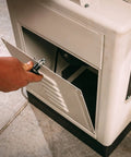 User adjusting the access panel of the six inch long bed jointer featuring helical cutterhead and 27 carbide inserts.