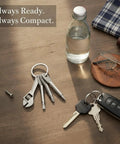 Compact Silver Keychain Multitool With Bottle Opener And Wrench For EDC Zinc Alloy Build Ultra Durable Everyday Carry Tool On Table