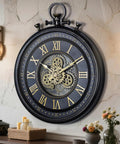 24 Inch Moving Gear Wall Clock Oversized Industrial Steampunk Decor With Big Numerals Carbon Black Finish mounted on wall.