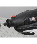 Handheld rotary tool in use for sanding on wood, part of Pro Grade 107 Piece Rotary Multitool Kit With 35000 RPM Variable Speed Dial.