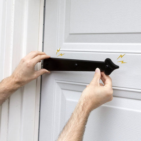 Close-up of hands installing a magnetic handle from the Magnetic Garage Door Hardware Kit 6 Piece Made From UV Stabilized ABS Plastic No Rust Or Flake Kid And Pet Safe Includes Two 12-Inch By 2-Inch Magnetic Handles For Quick Easy Install on a white garage door
