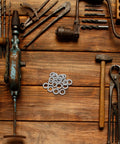 Set Of Twenty M10 Wedge Locking Washers Built Tough With Premium Manganese Steel on a wooden workbench with tools.