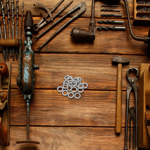 Set Of Twenty M10 Wedge Locking Washers Built Tough With Premium Manganese Steel on a wooden workbench with tools.