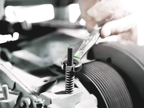 Joker 4pc Metric Ratcheting Combination Wrench Set with Secure Jaw Plate used on bolt, mechanical setting close-up.