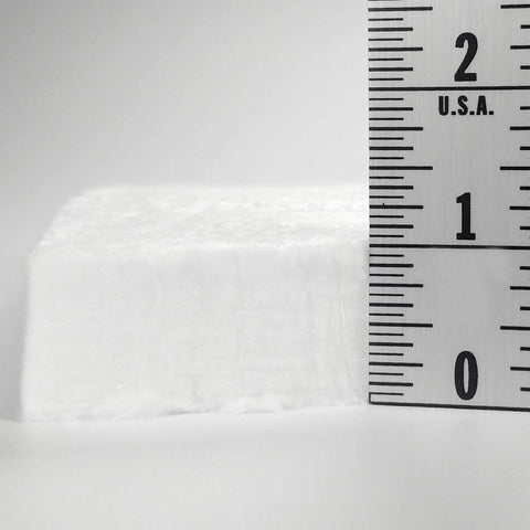 Ceramic fiber insulation, white, 1 in thick; side view with ruler.