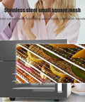 Stainless Steel Four Layer Electric Food Dehydrator With Adjustable Thermostat displaying dried fruit on mesh trays.