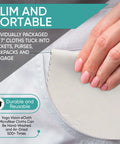 Close-up of hand holding gray microfiber cleaning cloth (6x7 in) for eyeglasses and screens.
