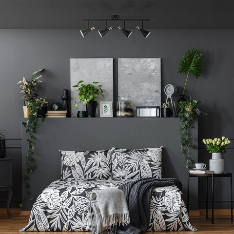 Bedroom with Dope Lofty Industrial Four Light Track Lighting Fixture with Pivoting Heads in Matte Black and Brass Accents over bed.