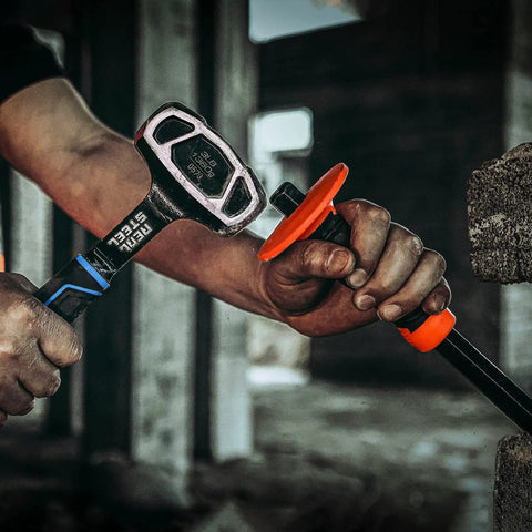 Person using Drilling And Crack Hammer 3 Lb Small Sledge One Piece Forged Steel Construction Tool on concrete, close-up view.