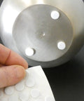 Applying Self Adhesive Three Eighths Inch Felt Furniture Pads Pack Of Seventy Five White Sliders to a metal base
