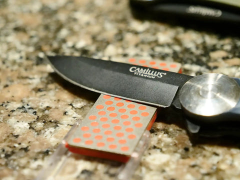 Pocket Diamond Sharpener With Monocrystalline Diamond Surface under knife blade on countertop