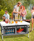Group enjoying outdoors using Go-To Aluminum Folding Camping Table With Adjustable Legs For Travel And Outdoors in a picnic setting