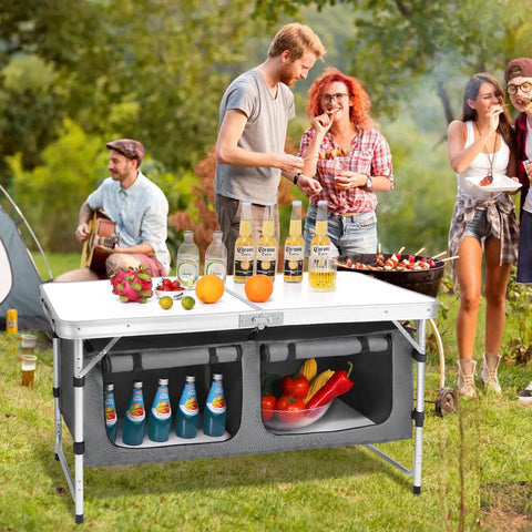 Group enjoying outdoors using Go-To Aluminum Folding Camping Table With Adjustable Legs For Travel And Outdoors in a picnic setting