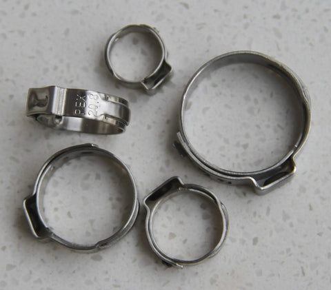 Heavy Duty Pex Pinch Clamps Kit With Five Sizes Three Eighths Inch One Half Inch Five Eighths Inch Three Quarters Inch And One Inch 50 Pieces Cinch Clamps For Securing Pipes And Hoses In Plumbing shown on a surface