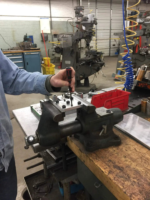 Person using a 10 Piece SAE Hex Key Set Allen Wrench Kit With Inch Sizes From 0.028 To 0.156 Inches Pro Grade Precision Screwdriver Quality Made In USA in a workshop setting.