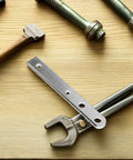 Heavy Duty Manual Rebar Bender 2 Piece Set For Bending Thick Metal Rods And Wire shown on a wooden surface with various tools.