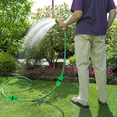 Person using 10 Sets Expandable Garden Hose Repair Kit With Dual Channel Connectors For Half Inch And Five Eighth Inch Hoses on grass