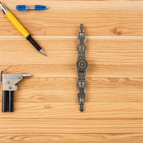 Focus keyword: Set Of 6 Vintage Zinc Alloy Cabinet Pull Handles For Kitchen Cabinets Dressers And Wardrobes Antique Drawer Knobs Durable Furniture Hardware Built To Last Through Daily Use. Single zinc alloy pull handle on wooden surface with tools, showcasing intricate design and durability.