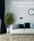 Wi-Fi Smart Color Thermostat With Energy Star Certified Performance on wall above sofa in modern living room.