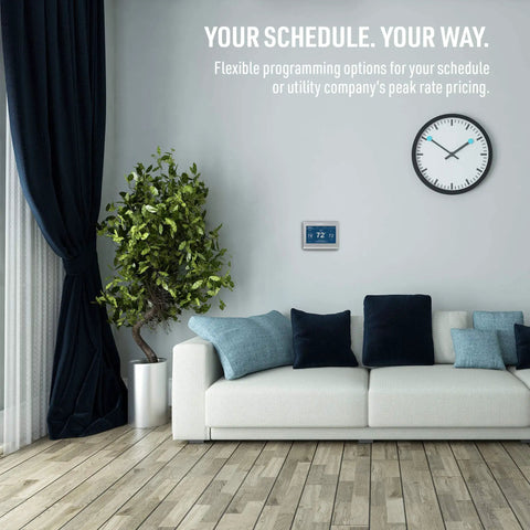 Wi-Fi Smart Color Thermostat With Energy Star Certified Performance on wall above sofa in modern living room.