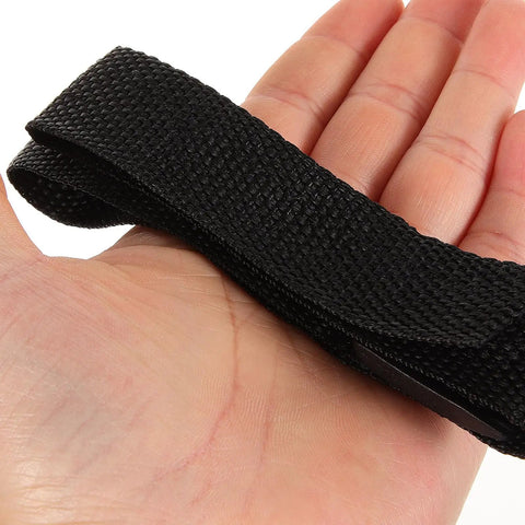 Hand holding black nylon strap for Adjustable Garden Aerator Shoes Straps Eight Pack For Lawn Care Spiked Sandals That Create Tiny Holes