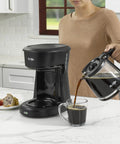 Person pouring coffee with Replacement Glass Carafe for 12 Cup Coffee Makers Compatible With LMX TP MMX MSX Series Easy Pour Spout