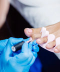 Heavy Duty Textured Nitrile Disposable Gloves Blue Medium 3.5 Mil Rugged Grip Workhorse Exam Gloves applied during pedicure.