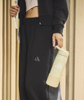 Double Wall Vacuum Insulated Metal Water Bottle With Secure Straw Lid Keeps Drinks Ice Cold Through The Daily Grind And On The Go Hustles For Gym Goers And Office Crews held by a person in athletic wear.