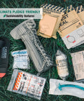 Top-down view of Rhino Rescue IFAK trauma kit with C-A-T tourniquet in black MOLLE pouch and assorted first-aid supplies