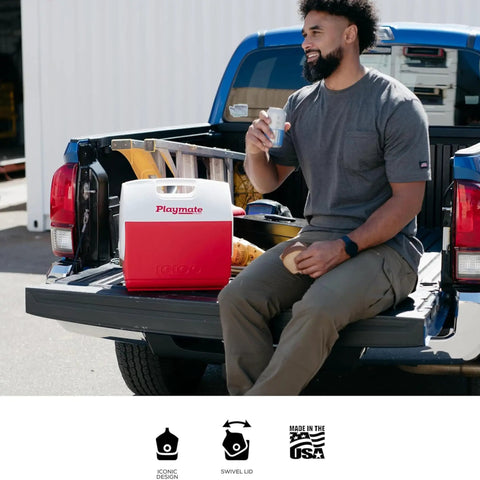 Man sitting on a truck tailgate with Playmate Elite Red Cooler With One Hand Opening Button Spill Proof Locking Lid Built In Carry Handle